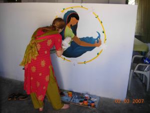 volunteer painting a mural