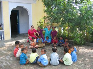 volunteers with local teachers and children